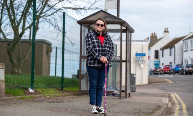 Kim Rennie waits for the 47 service at the Ferryden Pier bus stop. Image: Kim Cessford/DC Thomson.