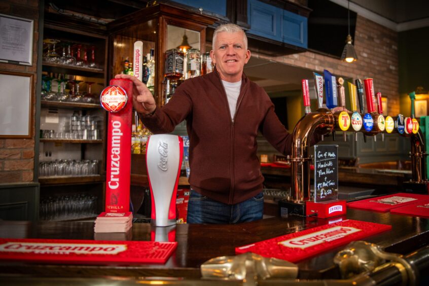 Jim Weir behind bar at King James pub, Perth
