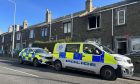 Police remain at the scene of the house fire on Pratt Street in Kirkcaldy.