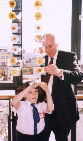 Scottish Secretary Donald Dewar with Mill of Mains primary pupil Erin Gallacher at the opening of the DCA. 