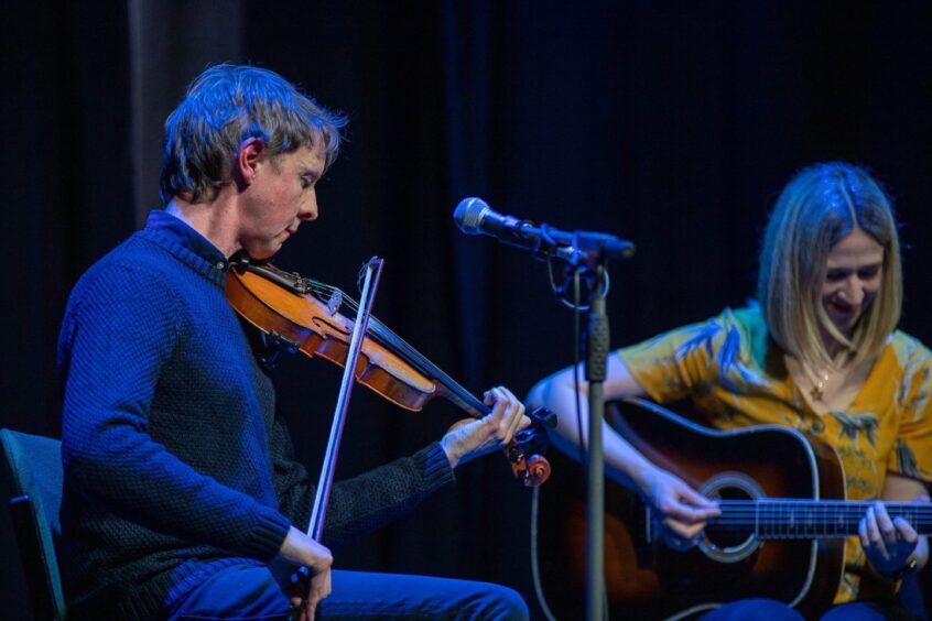 Adam Sutherland (fiddle) and Jenn Butterworth (guitar) on stage at Birnam Arts