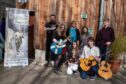Group of musicians with fiddles outside Birnam Arts venue where Niel Gow Festival events are being held
