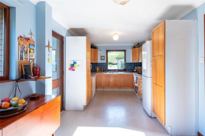 A utility rooms sits off the kitchen. 