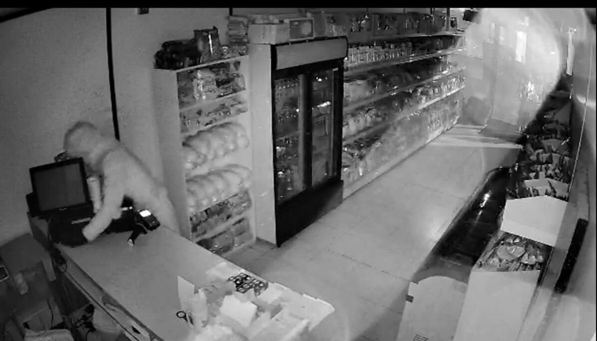 One of the thieves inside the shop