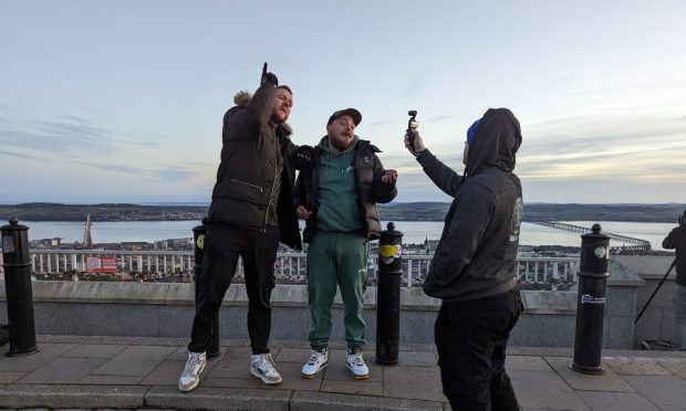 Red King (Tommy Dey) left, shooting a music video at the top of Dundee Law.