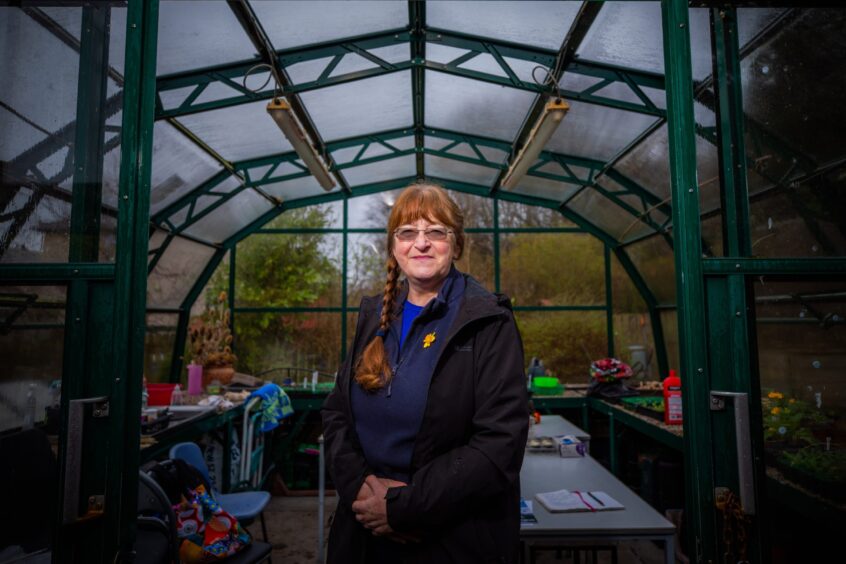 Amanda James, standing in greenhouse in Potager community garden, Kinross.