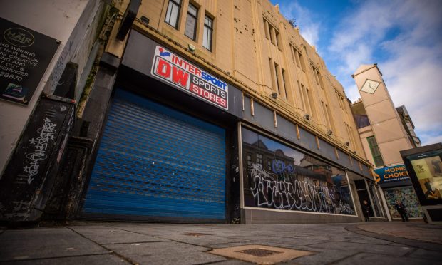 The boarded-up frontage of DW Sports in Murraygate, Dundee.