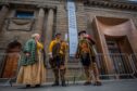 three people dressed as characters from Scottish history outside Perth Museum