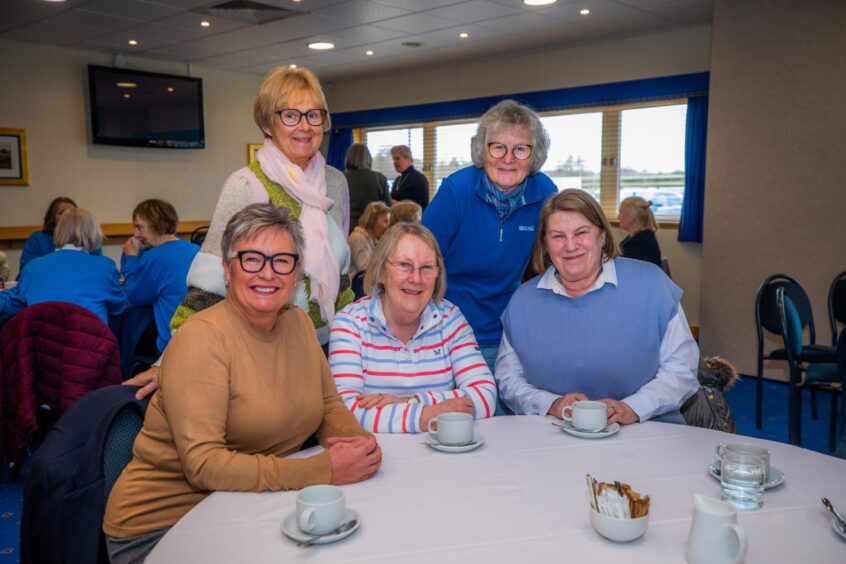 Linda Cryan, Kate Hood, Barbara Dowdeswell, Linda Riseborough and Rhona Christie seated and standing at a round table at the Perthshire Riding for the Disabled lunch in McDiarmid park