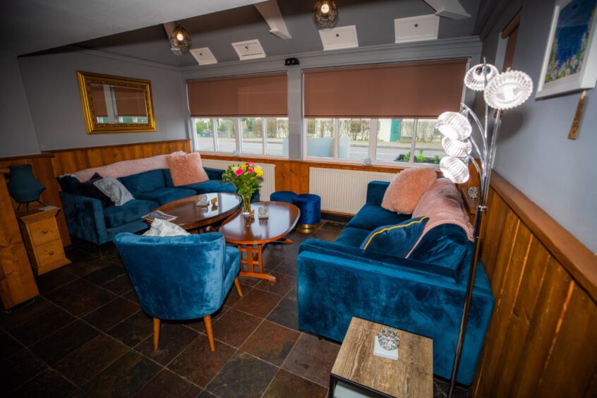 Interior of the snug at The Anglers, Guildtown, showing comfortable sofas and coffee tables