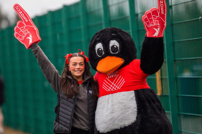 Piper the Penguin and Mia Jennings (vice-president of sport, University of Dundee) cheer on the teams!