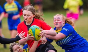 Women's Rugby with A player from the University of Dundee is tackled by players from Abertay University as the teams compete for the Varsity Trophy.