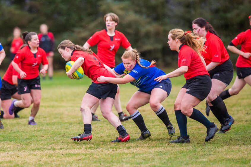 Women's Rugby with University of Dundee in Red vs Abertay University in blue and yellow.