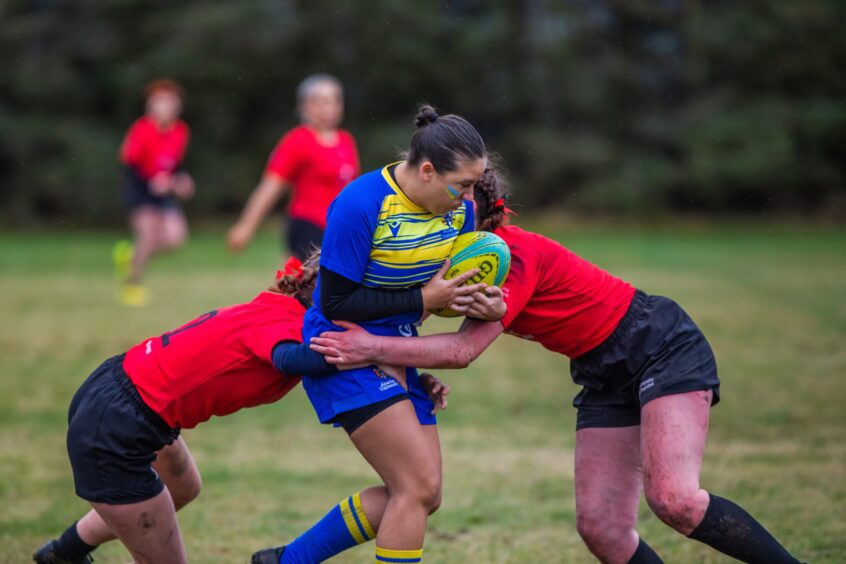 Heavy contact during the women's rugby match. 