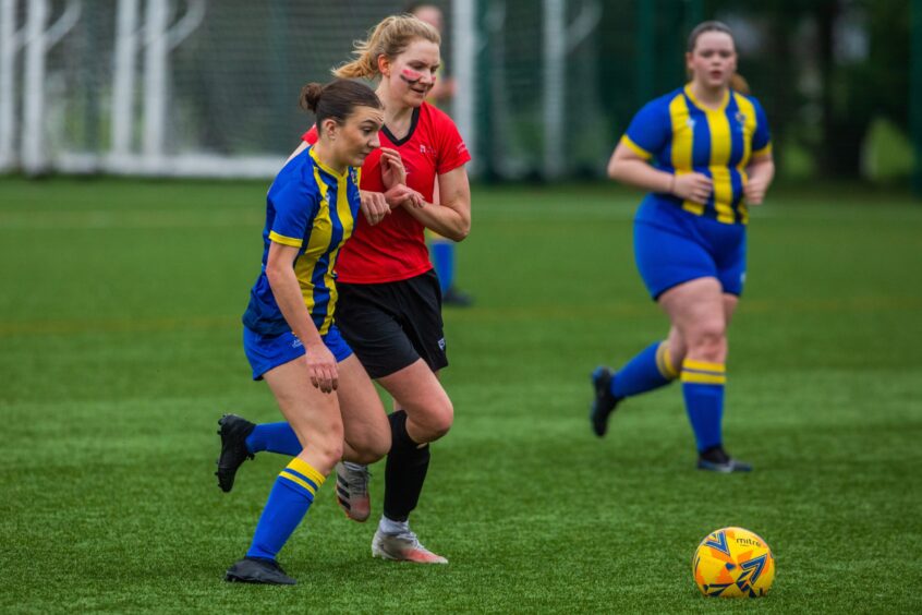 Women's Football with University of Dundee in Red vs Abertay University in blue and yellow.