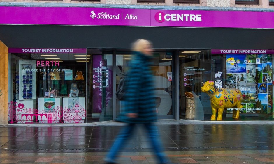 The VisitScotland centre in Perth with person walking past