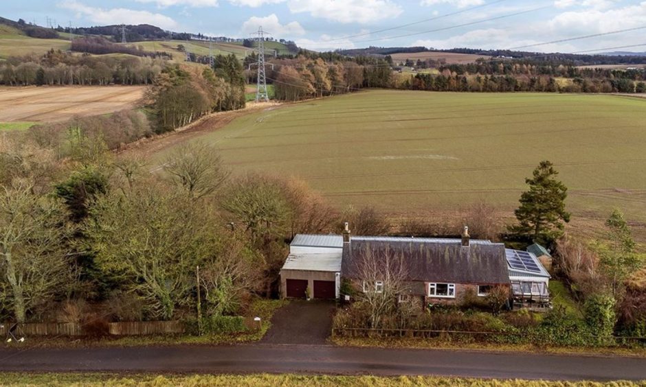 An aerial view of Soutra Cottage, with the fields surrounding it  in the Angus Glens. 