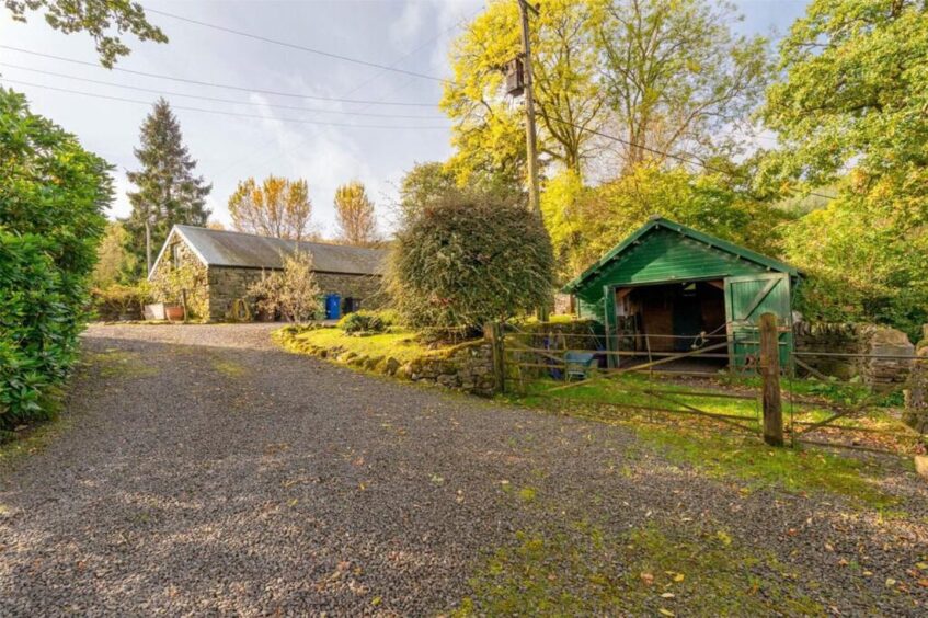 The estate features a range of outbuildings including barns, garages and storage units.
