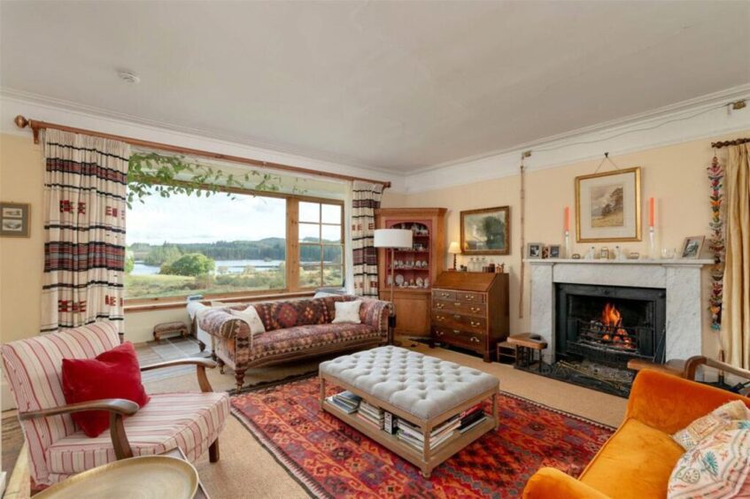 The living room has stunning views over the grounds and Loch Ard. 
