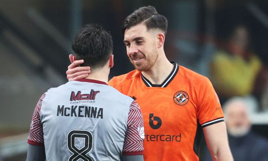 Michael McKenna chats with Dundee United's Declan Gallagher after a 4-0 defeat for Arbroath at Tannadice.