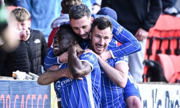 Nicky Clark (centre) celebrates with goal-scorer Adama Sidibeh (left) and Ryan McGowan (right) during St Johnstone's defeat to Dundee. Image: SNS