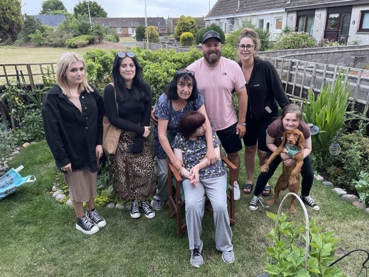 Caroline and Becky with son and brother Bill, his partner and three daughters in the back garden