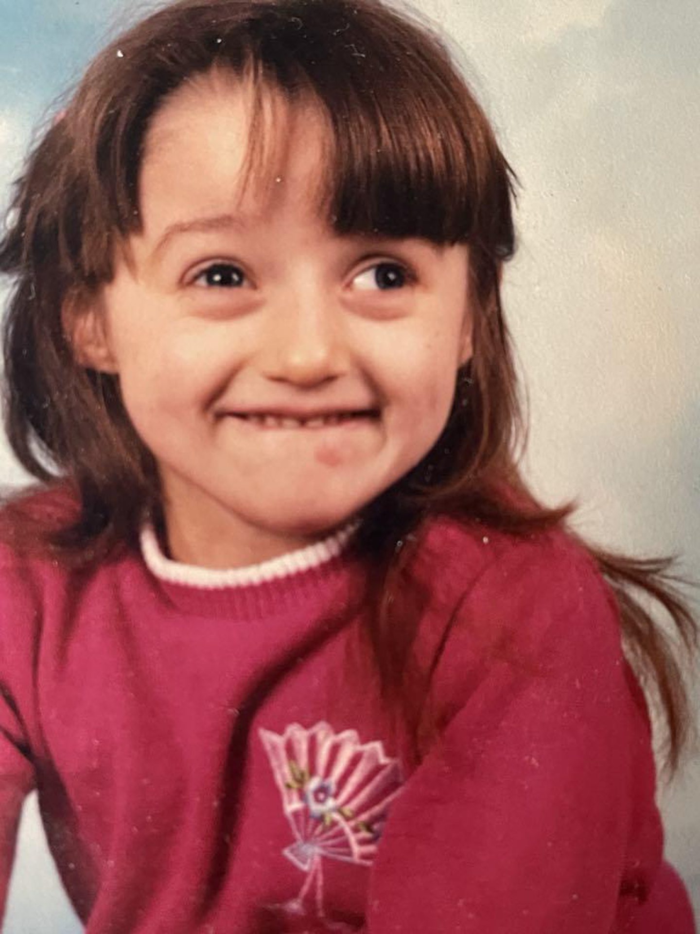 A picture of a smiling Becky as child.