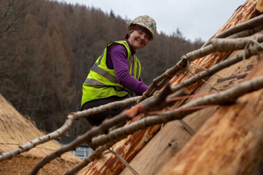 Caroline Nicolay, living history creator, gets to grips with a roof at the new Scottish Crannog Centre.