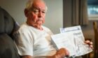 Jim Smith with the demands from British Gas sent after his wife's death. Image: Mhairi Edwards/DC Thomson