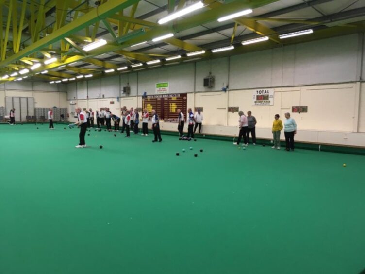 Group of bowlers on indoor rink at Dewars centre, Perth