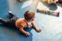 A baby playing with blocks. Image: Shutterstock