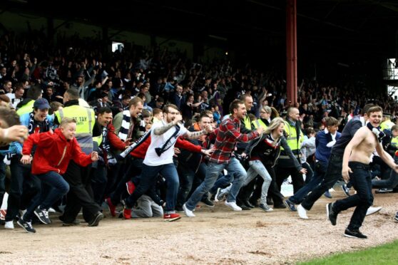 The Dundee fans invade the pitch at the final whistle. Image: DC Thomson.