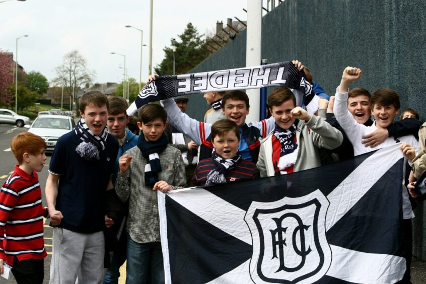 Dundee supporters with a flag and scarves before the final game at Dens Park in 2014. 