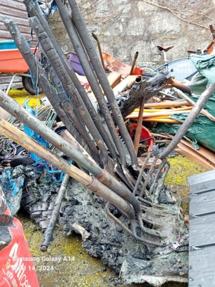 A pile of charred garden forks