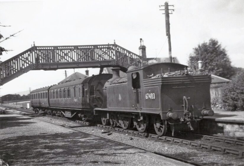 A train goes under a bridge at Kingennie Station, which was among the stopping points on the route.