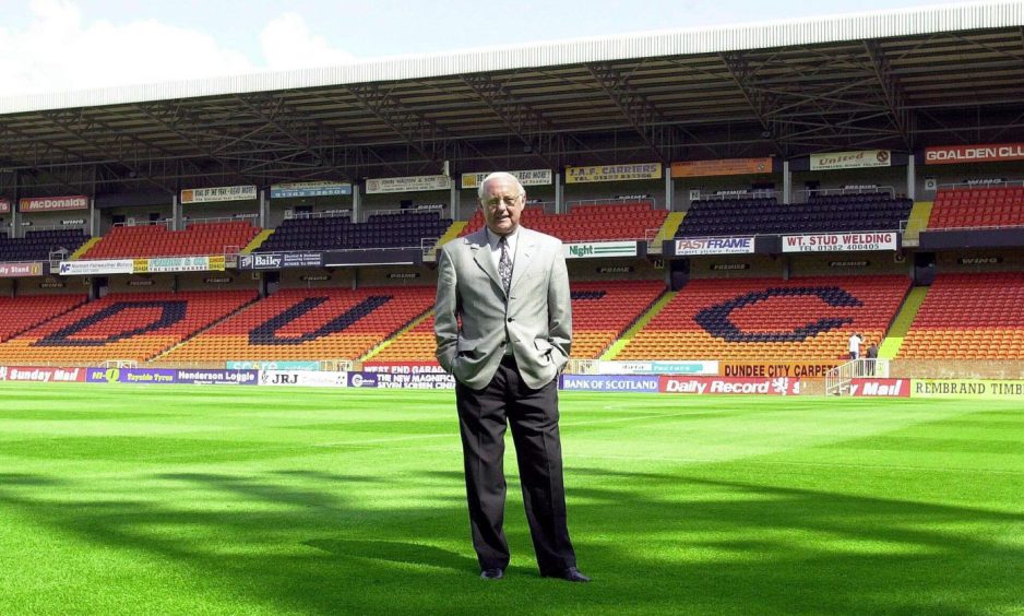 Jim McLean stands on the picth at Tannadice Park with an empty stand behind him