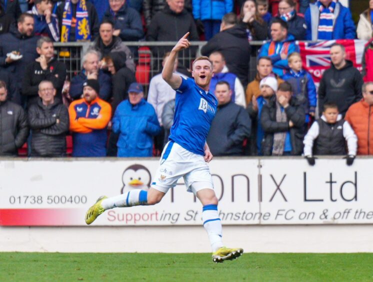 James Brown runs away and holds his right hand in the air as he celebrates scoring for St Johnstone against Rangers.