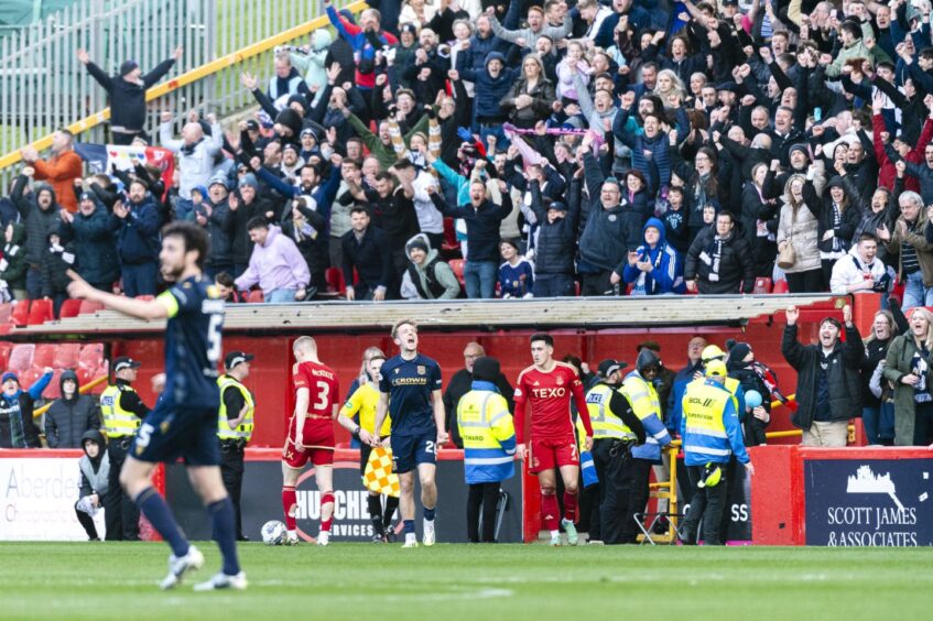 Dundee fans celebrate at Aberdeen as the Dark Blues secure top six.
