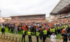 The scenes as delighted United fans took over the Tannadice turf to toast the triumph
