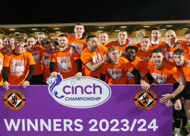 The Dundee United players celebrate their title win being made official