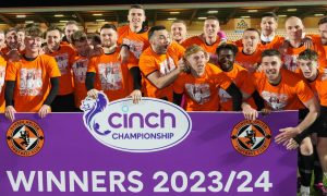 The Dundee United players celebrate their title win being made official