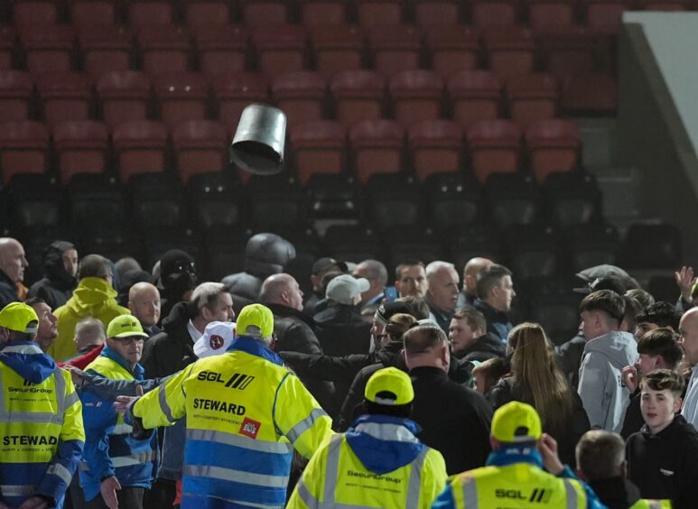 A bucket is thrown as Dundee United and Airdrie fans clash