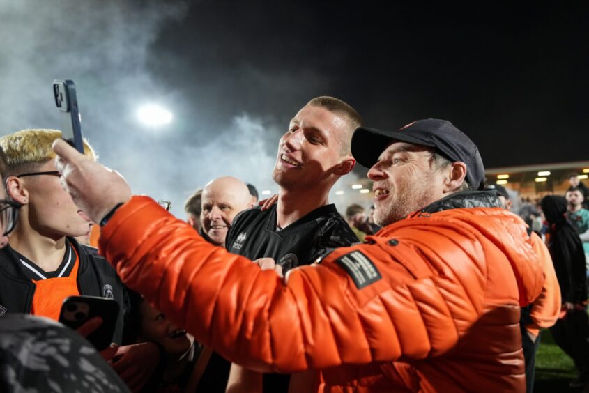 Sam McClelland, pictured taking a selfie with a fan, helped Dundee United to another clean sheet