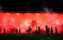 The use of pyrotechnics - like those which held up a game at Dens Park earleir this season - was slammed by the sheriff. Image: Ross Parker / SNS Group)