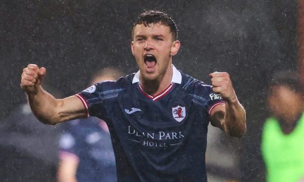 Raith Rovers midfielder Ross Matthews raises two clenched fists and shouts.