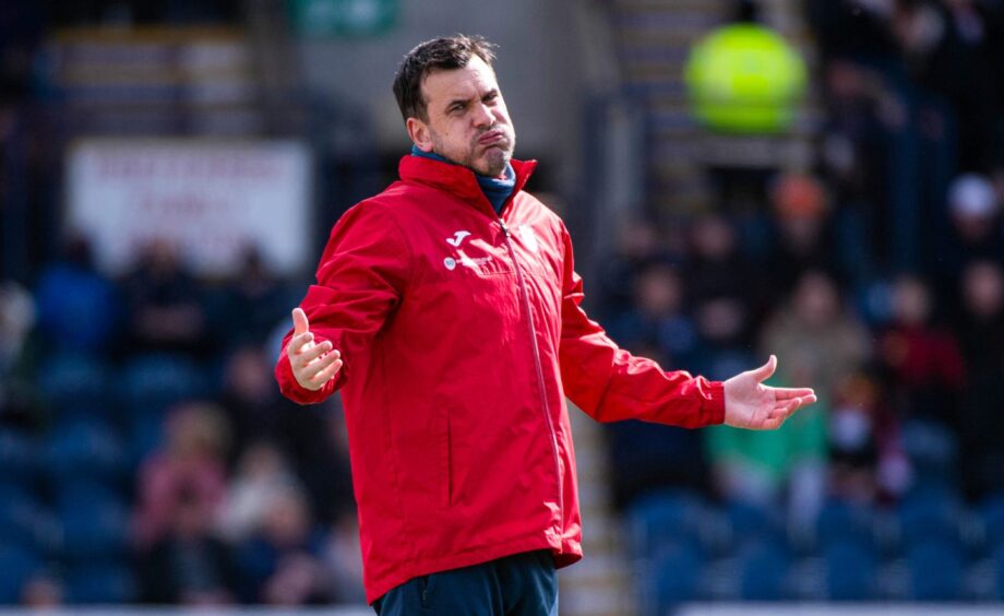 Raith Rovers manager Ian Murray blows out his cheeks and throws out his arms as he questions a refereeing decision.