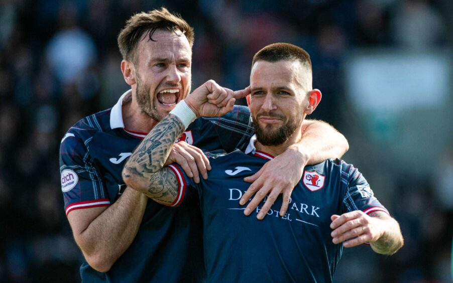 Dylan Easton points to his temple as he celebrates Raith Rovers' opening goal with a delighted Keith Watson.