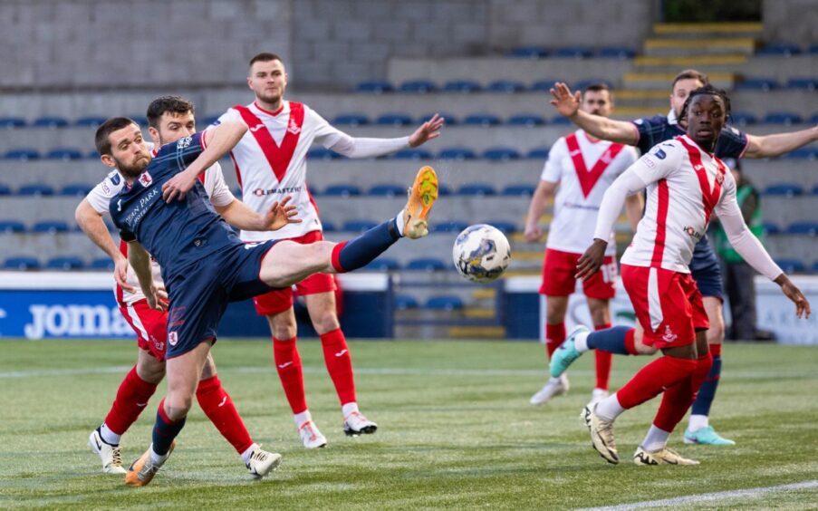 Raith Rovers midfielder Sam Stanton stretches for a ball with his left foot in a game against Airdrie.