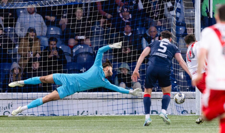 Raith Rovers goalkeeper Kevin Dabrowski dives to his left as he fails to reach the ball as it goes into the corner of the net.