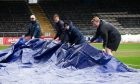 Dens ground staff relay pitch covers. Image: Ewan Bootman/SNS